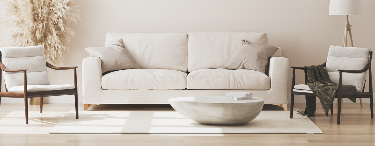 A softly lit living room with neutral furnishings and warm natural textures